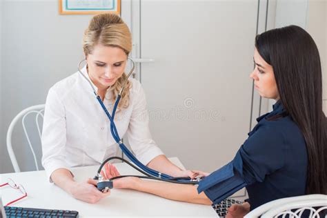 Doctor Measuring Pressure Of The Pregnant Woman Doctor Taking Blood