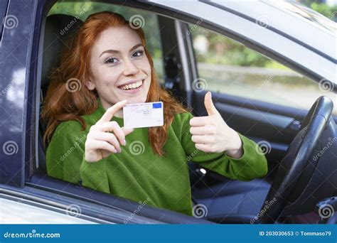 Young Woman At The Wheel Showing Driving License Stock Image Image Of