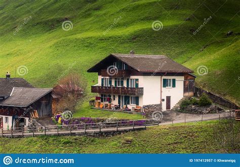 Countryside Valley View Of Swiss Alps With Traditional Swiss House At
