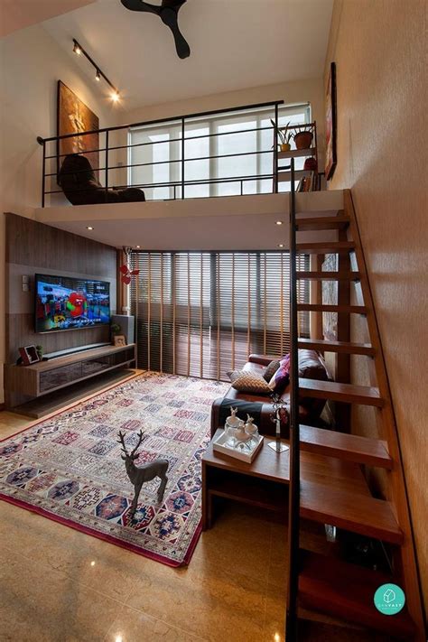 A Living Room With Stairs Leading Up To The Top Floor And A Loft Bed