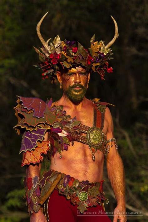 A Man In Costume With Horns And Flowers On His Head