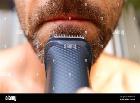 Hair clipper used to trim a man's beard with little money to save