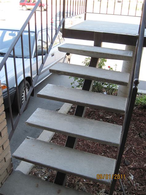 Repairs on a concrete staircase. Straight Iron Stairs - The Iron Anvil - Salt Lake City, Utah