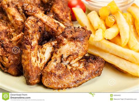 Chicken Wings With Fries French And Spicy Sauce Stock