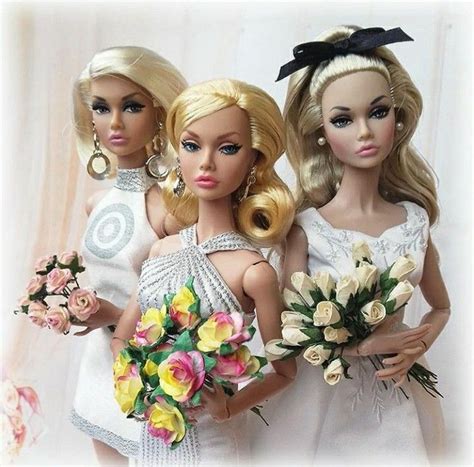 Three Barbie Dolls Are Holding Bouquets Of Flowers