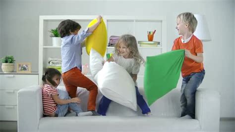 Four Kids Playing On Sofa Pillow Fighting Stock Video Footage Dissolve