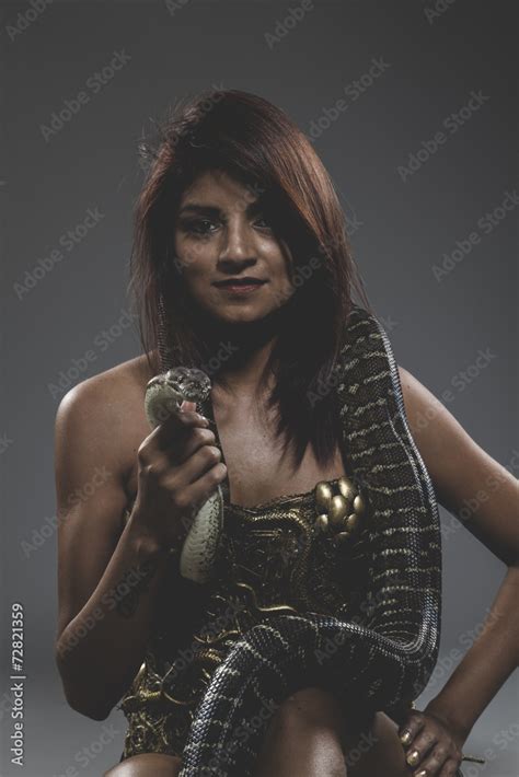 Sexy Warrior Tattooed Woman With Big Snake And Iron Corset Stock Photo