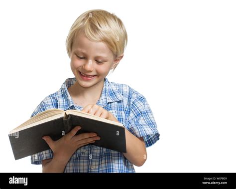 A Happy Young Boy Holding And Reading A Thick Book Isolated On White