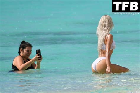 Kim Kardashian Shows Off Her Sexy Figure In A White Bikini During An