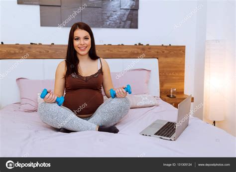 Beautiful Pregnant Woman Exercising At Home — Stock Photo © Nd3000