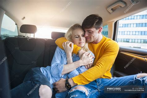 Couple In Love Cuddling On Back Seat Of A Car — Togetherness Male