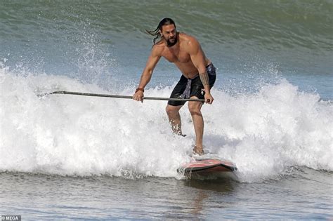jason momoa exhibits his toned chest as he goes surfing in hawaii after wrapping aquaman daily