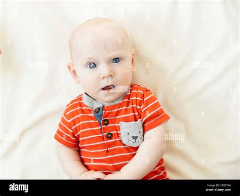 Confused Baby Boy Lying On Bed Stock Photo Alamy