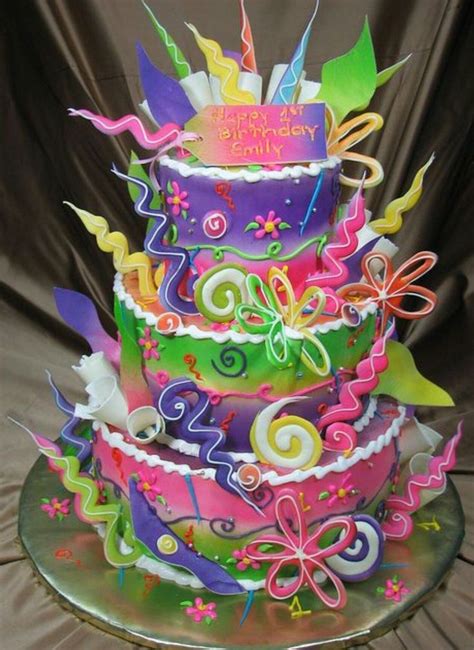 A Multi Tiered Birthday Cake Decorated With Ribbons And Decorations