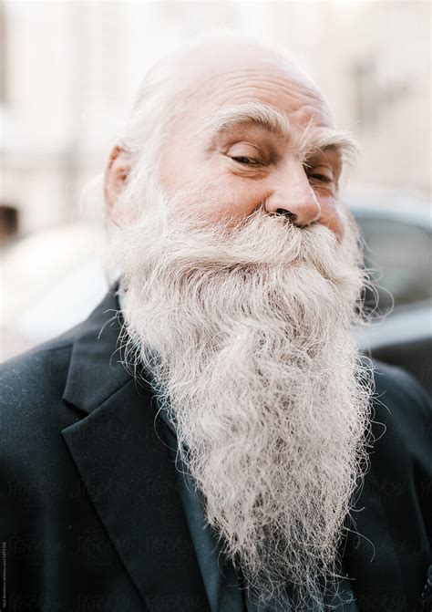 Deciding to let your hair grow long is not much different than deciding to grow a full beard, i.e., you need time, patience, and an idea of what you want. close up portrait of old man with white Gray-haired beard ...