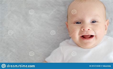 Child`s Face Of A Happy Newborn Baby Looking To Camera Healthy Newborn