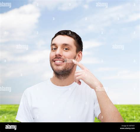 Smiling Young Handsome Man Pointing To Cheek Stock Photo Alamy