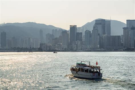 Tourist Boat Crossing Victoria Harbor In Hong Kong At Sunrise Stock