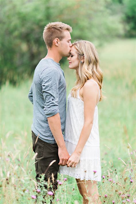 Blonde Couple In Field On Their Whimsical Outdoor Engagement Shoot