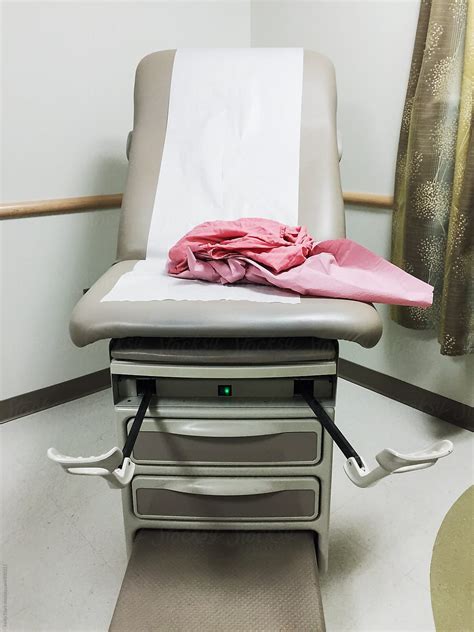 Gynecologist Exam Table With A Pink Exam Gown Del Colaborador De Stocksy Holly Clark Stocksy