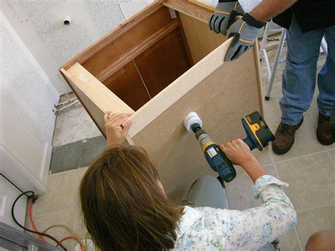 Installing a bathroom cabinet increases storage space in a cramped bathroom and adds a decorative touch to your walls. How to Install a Vanity in a Master Bathroom | how-tos | DIY
