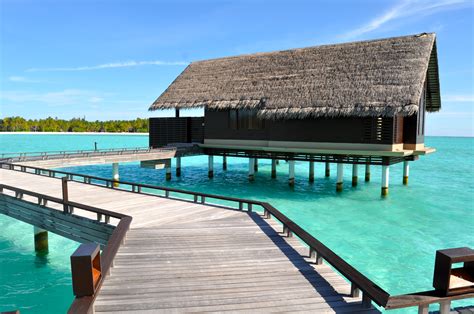 Brown Wooden House In Body Of Water Under Blue Sky Maldives Hd