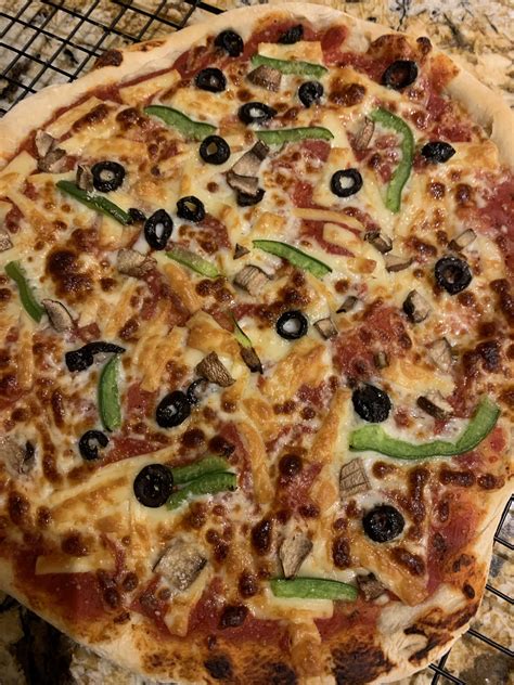 Home Made New York Style Pizza With Black Olives Mushrooms Green