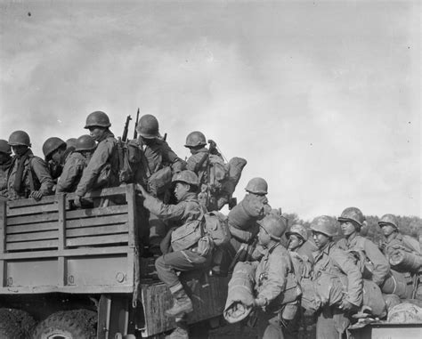 Japanese American Troops Climb Into A Truck As They Prepare To Move