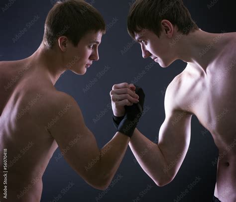 Two Muscular Men Fighting On A Dark Background Stock Photo Adobe Stock