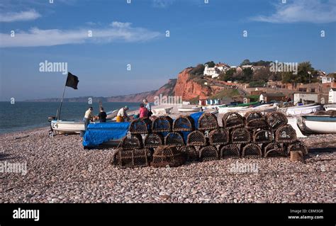 Budleigh Salterton Beach With Lobster Pots And Boats Cliffs In The Background Devon England