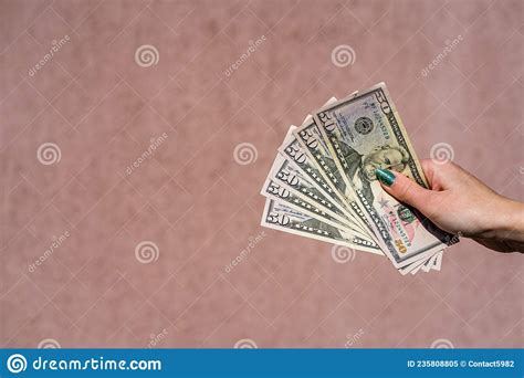 hand holding showing dollars money and giving or receiving money like tips salary 50 usd