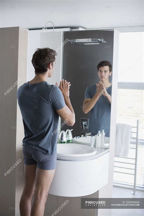 Reflection Of Man Looking At Bathroom Mirror — Selfishness Male