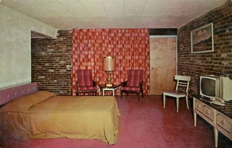 An Old Photo Of A Motel Room With A Bed And Television