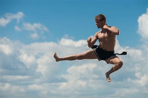 Premium Photo Man Flying Kick In Sky