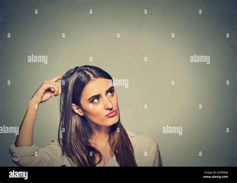 Contused Thinking Woman Bewildered Scratching Her Head Seeks A Solution Isolated On Gray Wall
