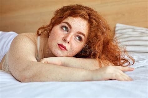 Red Haired Chubby Woman In Lingerie Lies On Bed Have Rest Stock Photo