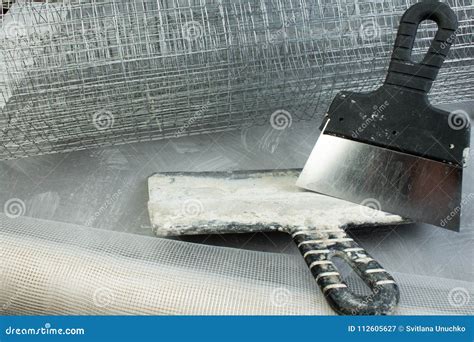 Roll Mesh For Plastering Putty Knife On The Gray Concrete Background