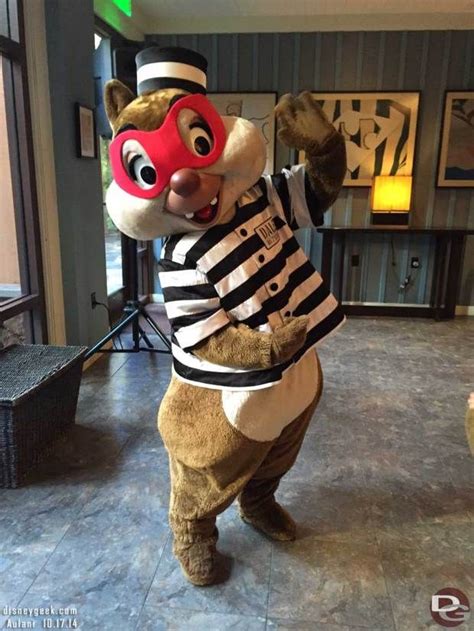 The Mascot Is Dressed In Jail Clothes And Holding A Red Mask On His Head