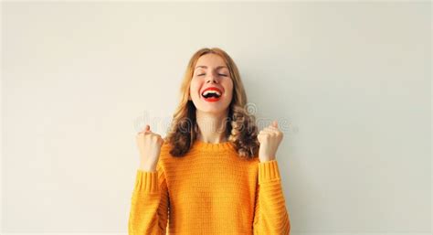 Portrait Of Overjoyed Happy Young Woman Doing Winner Gesture Celebrate