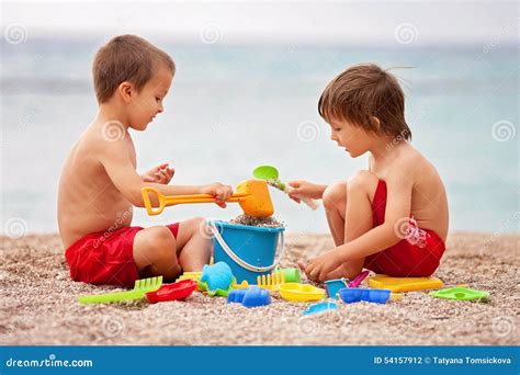 Two Cute Kids Playing In The Sand Stock Photo Image Of Foreground