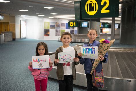 Kids With Welcome Signs At Airport By Stocksy Contributor Ronnie