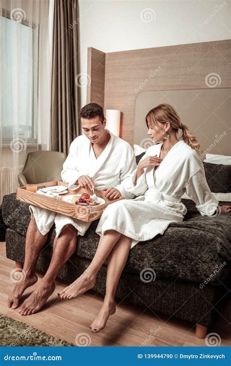 Couple Wearing Hotel Bathrobes Sitting On Hotel Bed Stock Photo Image
