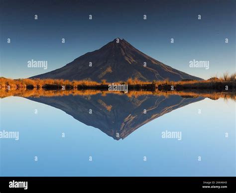 Mount Taranaki Reflected In The Water Of A Small Tarn Stock Photo Alamy