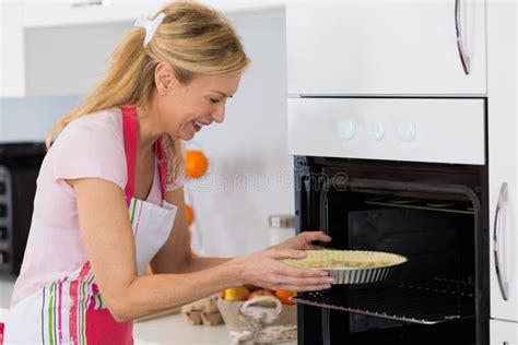 Pretty Blond Woman Putting Tart In Oven For Baking Stock Image Image