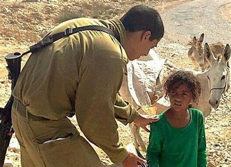 Image Of Israeli Soldier Giving Food To Arab Girl Rummaging Through