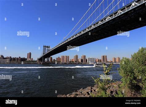 Ferry Passing Under The Manhattan Bridge East River New York City Stock