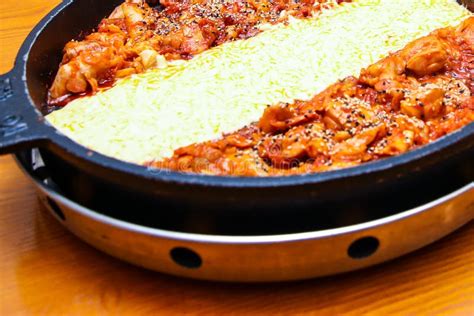 Korean Spicy Chicken Stir Fry Dakgalbi With Cheese On A Big Iron Pan