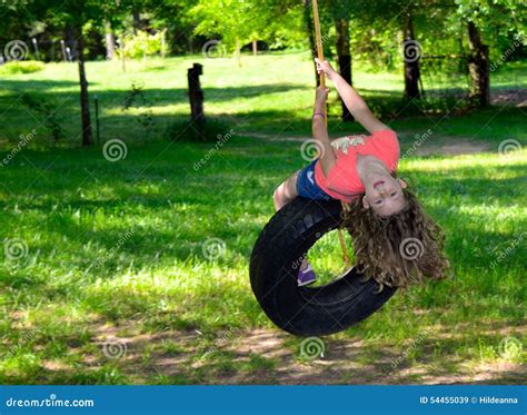 Young Girl Playing On A Tire Swing Stock Image Image Of Motion