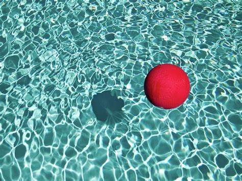 Floating Red Ball In Blue Rippled Water Photograph By Mark A Paulda