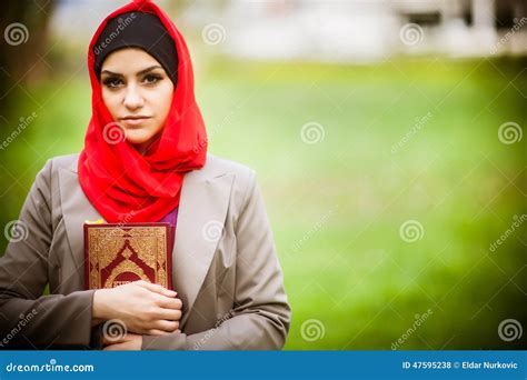 Beautiful Muslim Woman Wearing Hijab And Holding A Holy Book Koran